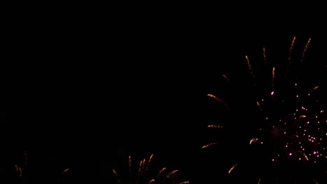 explosions of colorful bright lights filling the night sky at a beachfront of a popular tourist destination in southeast asia for an international fireworks festival