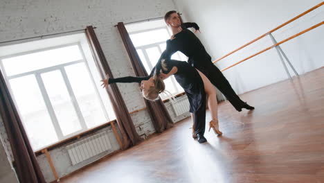 elegant ballroom dance couple performing in a studio