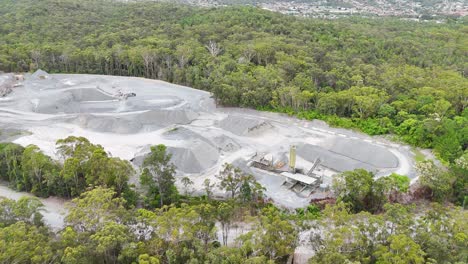 quarry surrounded by dense forest from above