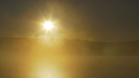 sunrise over a misty lake