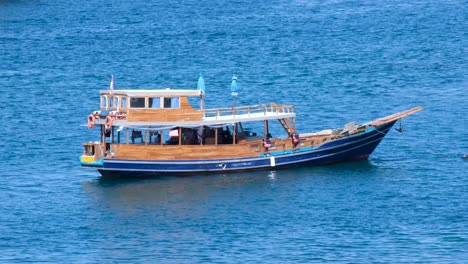 Solo-liveaboard-boat-drifting-on-stunning-blue-ocean-in-Labuan-Bajo-on-Flores-Island,-Nusa-Tenggara-region-of-east-Indonesia