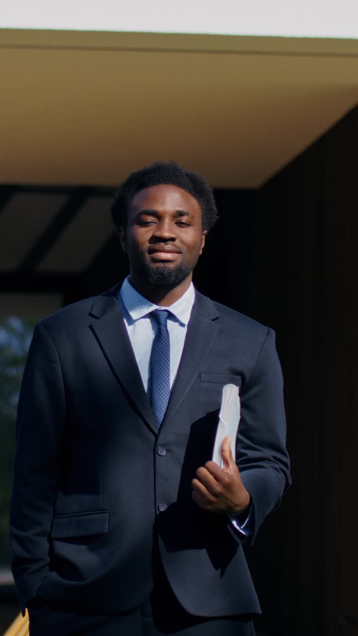 Businessman holding documents outside