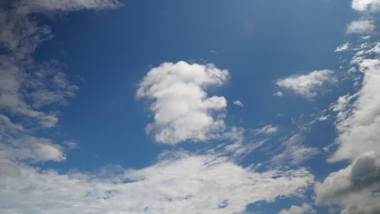 Clouds drift across the sky, creating a dynamic and ever-changing landscape as they move gently above the horizon.