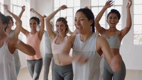 group of multi ethnic women learning dance moves enjoying fitness instructor teaching dancing choreography showing routine having fun in studio