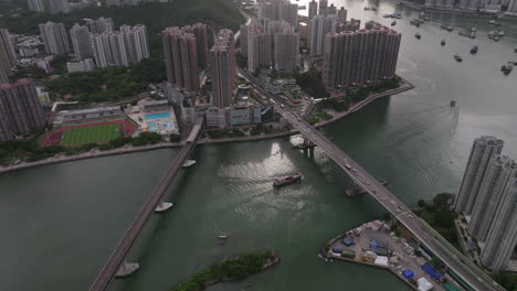 Approaching-tilt-down-shot-of-Tsing-Tsuen-bridge-and-train-bridge-in-front-of-Tsing-Yi-Island-in-Hong-Kong-at-sunset