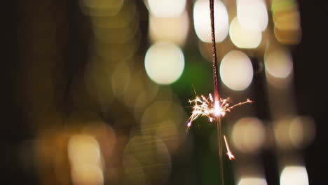 burning sparkler with bright bokeh lights animation, creating festive atmosphere