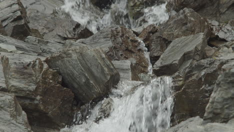 water runs thru rocks and bedrock in slow motion