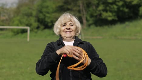 Active-senior-elderly-80-years-old-caucasian-woman-do-morning-physical-exercises