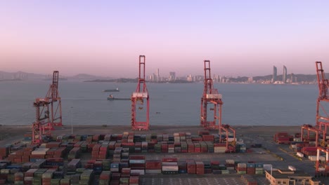 aerial video of cranes and containers at the wharf at dusk