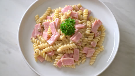 spirali or spiral pasta mushroom cream sauce with ham - italian food style