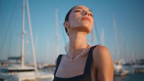 woman enjoying a sunset at the marina