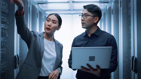 it technicians inspecting server racks