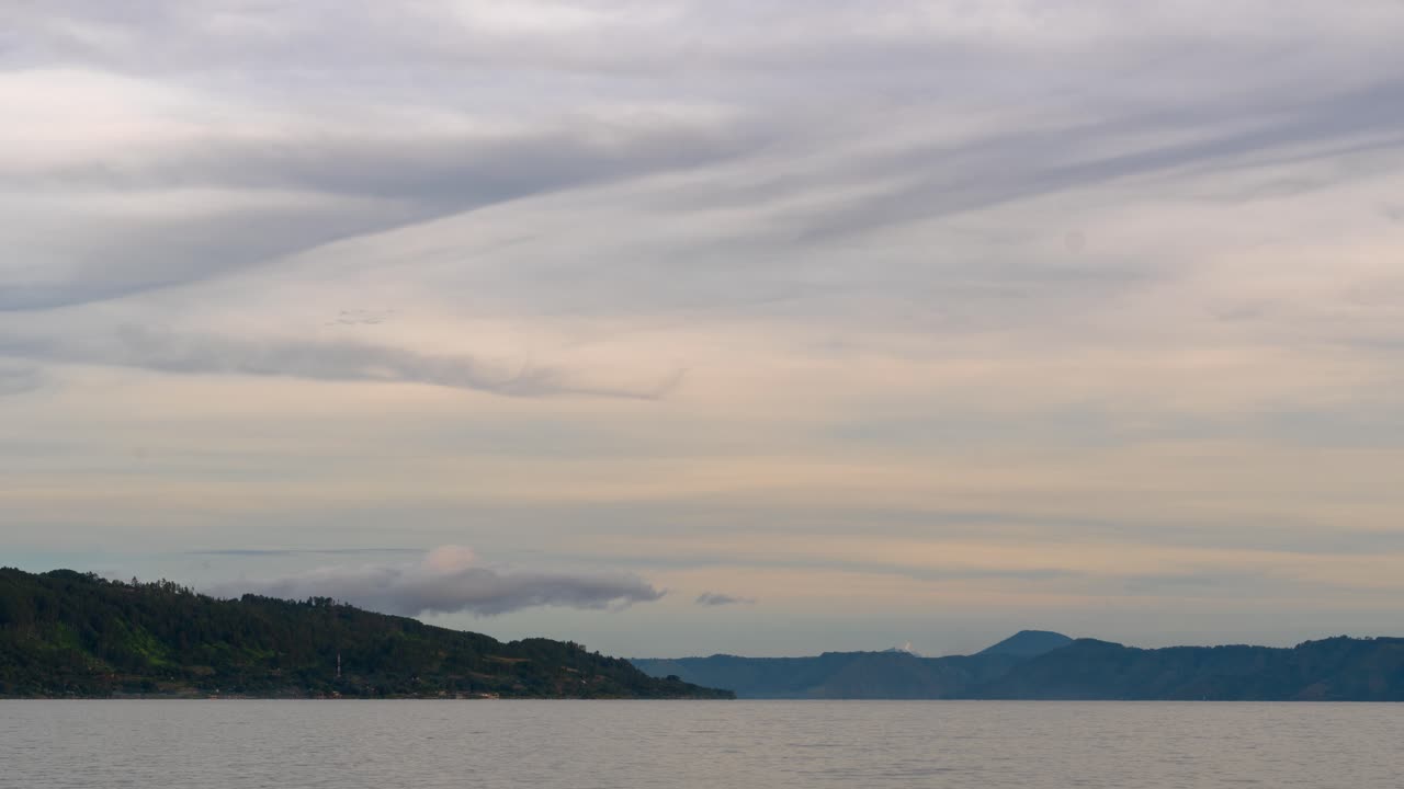 Tranquil Lake and Mountain Landscape Under a Cloudy Sky