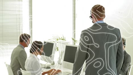 Animation-of-moving-lines-over-business-people-wearing-phone-headsets