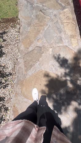 person walking on a stone path