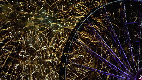 Colorful-fireworks-at-a-ferris-wheel,-during-nighttime-in-Chicago,-Illinois,-USA