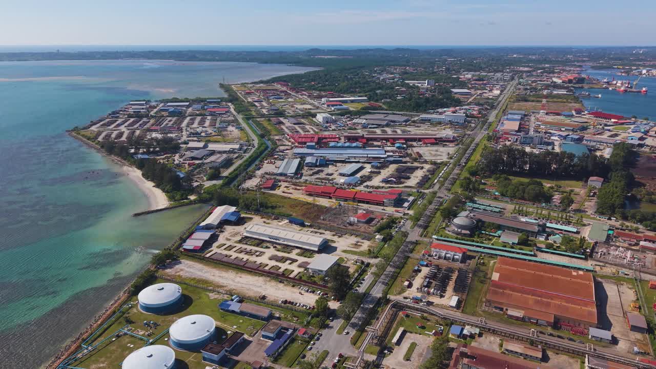 Aerial view of the Rancha-Rancha Industrial Estate in Labuan, Malaysia, showing coastal industrial infrastructure, storage tanks, and factory zones along the shoreline