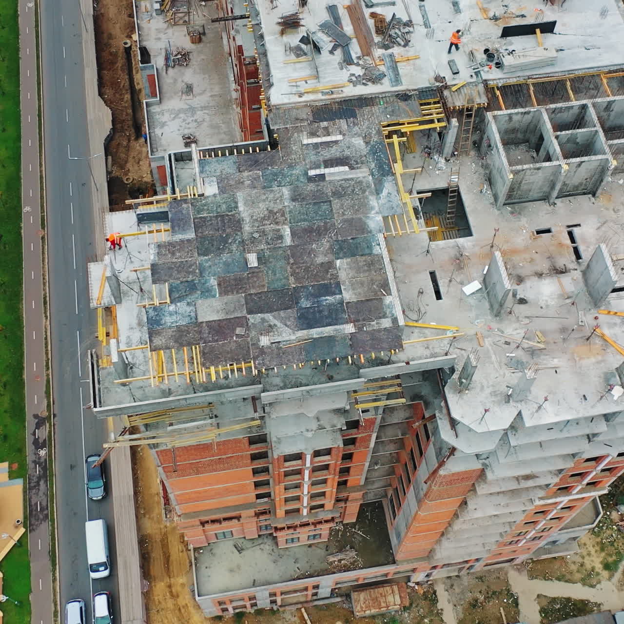 Construction of a residential apartment complex. Aerial view. Workers on the roof.