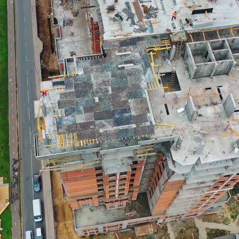 construction of a residential apartment complex. aerial view. workers on the roof.
