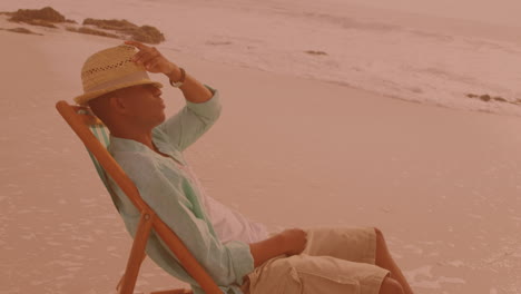 african american man sitting on the chair and relaxing at the beach