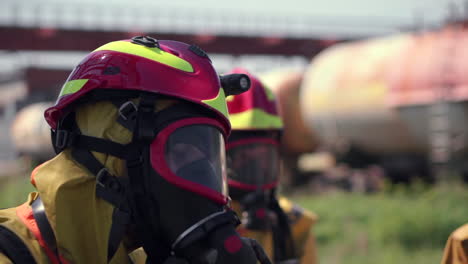 firefighters in protective gear at an industrial site