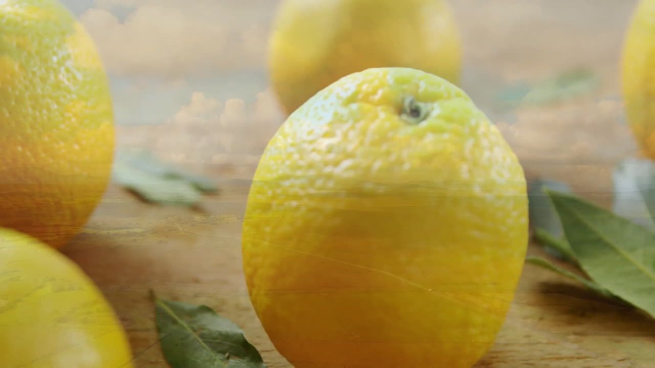 Showcasing vibrant colors, fresh lemons with green leaves on wooden surface