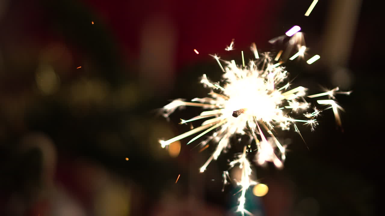 Lighting a sparkler, mounted on a christmas tree in 4K.