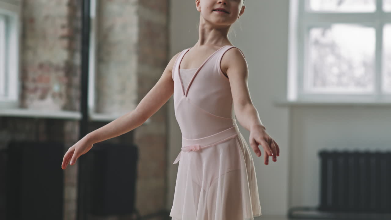 Little Ballerina Posing While Standing On Her Toes