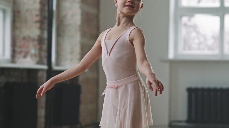 Little Ballerina Posing While Standing On Her Toes