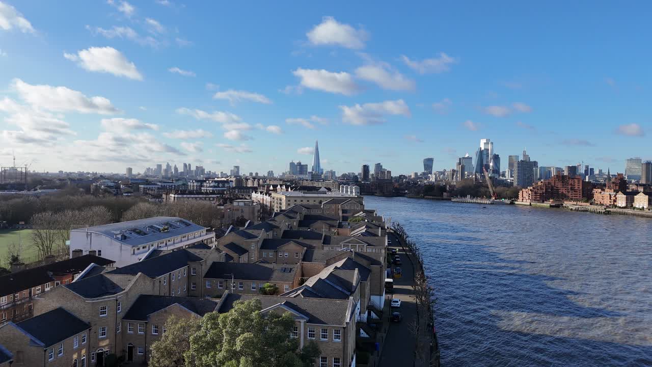 Panning drone aerial Thames riverside apartments Rotherhithe London 4K footage