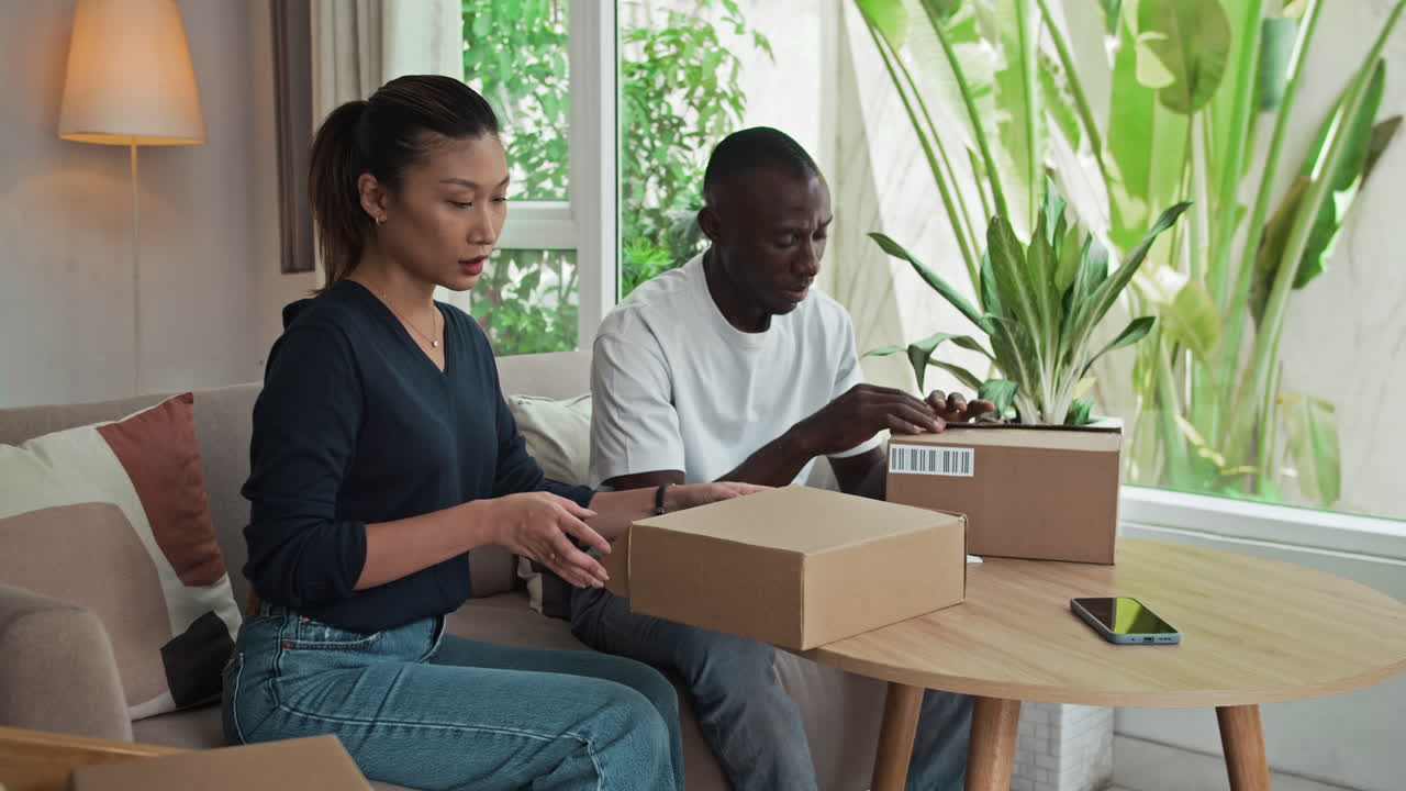 Diverse Couple Checking Their Purchases Ordered Online