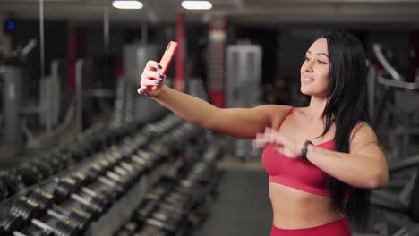 sexy girl taking a selfie on the phone in the gym