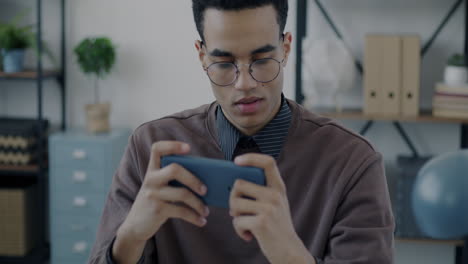young man using smartphone in office