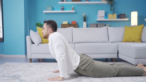 Young-fitness-teacher-demonstrates-cobra-stretch-at-home.