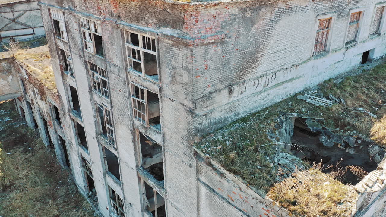 Ruined roof of an old abandoned factory. Industrial building for demolition. Aerial view.
