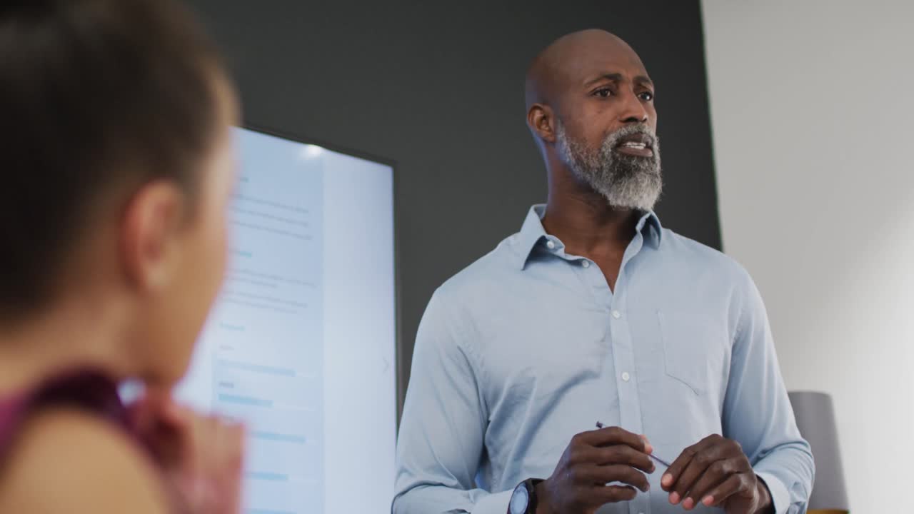 Happy diverse business people discussing work during meeting at office