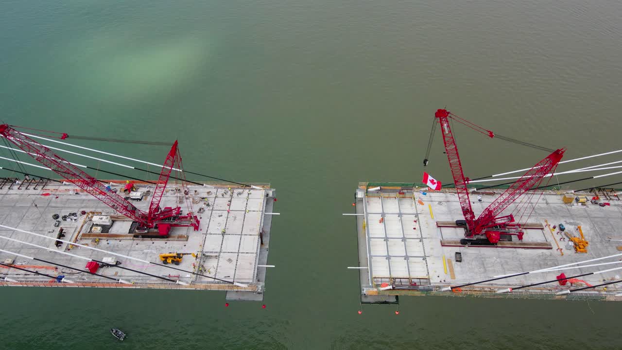 Final stage of Gordie Howe International Bridge being built over Detroit river in aerial top down view