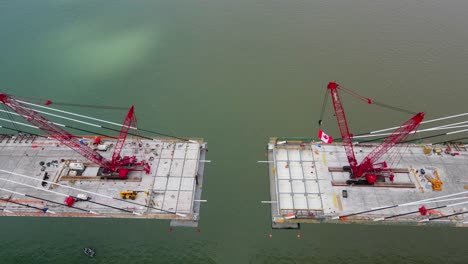 final stage of gordie howe international bridge being built over detroit river in aerial top down view