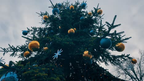 beautiful christmas tree full of big flasks and christmas decorations along with flashing lights