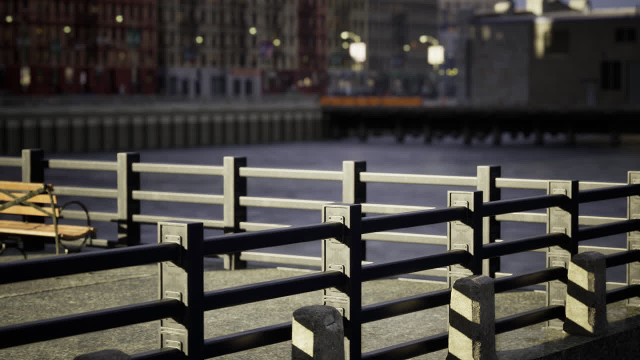 City waterfront promenade with railing and bench during sunset hours