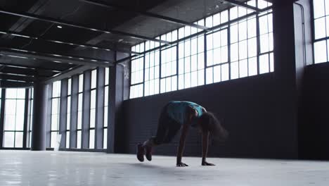 african american woman doing jumping exercises in an empty urban building