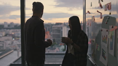 Man-silhouette-bringing-coffee-sunset-office-closeup.-Couple-drinking-beverage