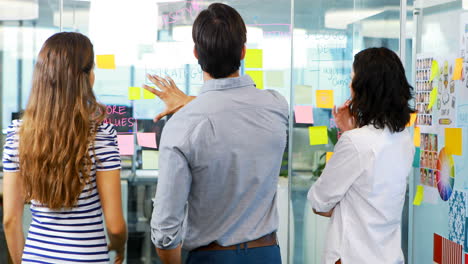 grupo de ejecutivos discutiendo sobre notas adhesivas