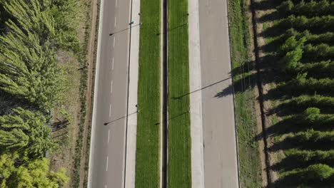 aerial view over a road in the countryside surrounding areas of general roca, cordoba, argentina