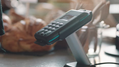 close up customer paying using smartphone contactless payment in cafe enjoying service spending money at restaurant