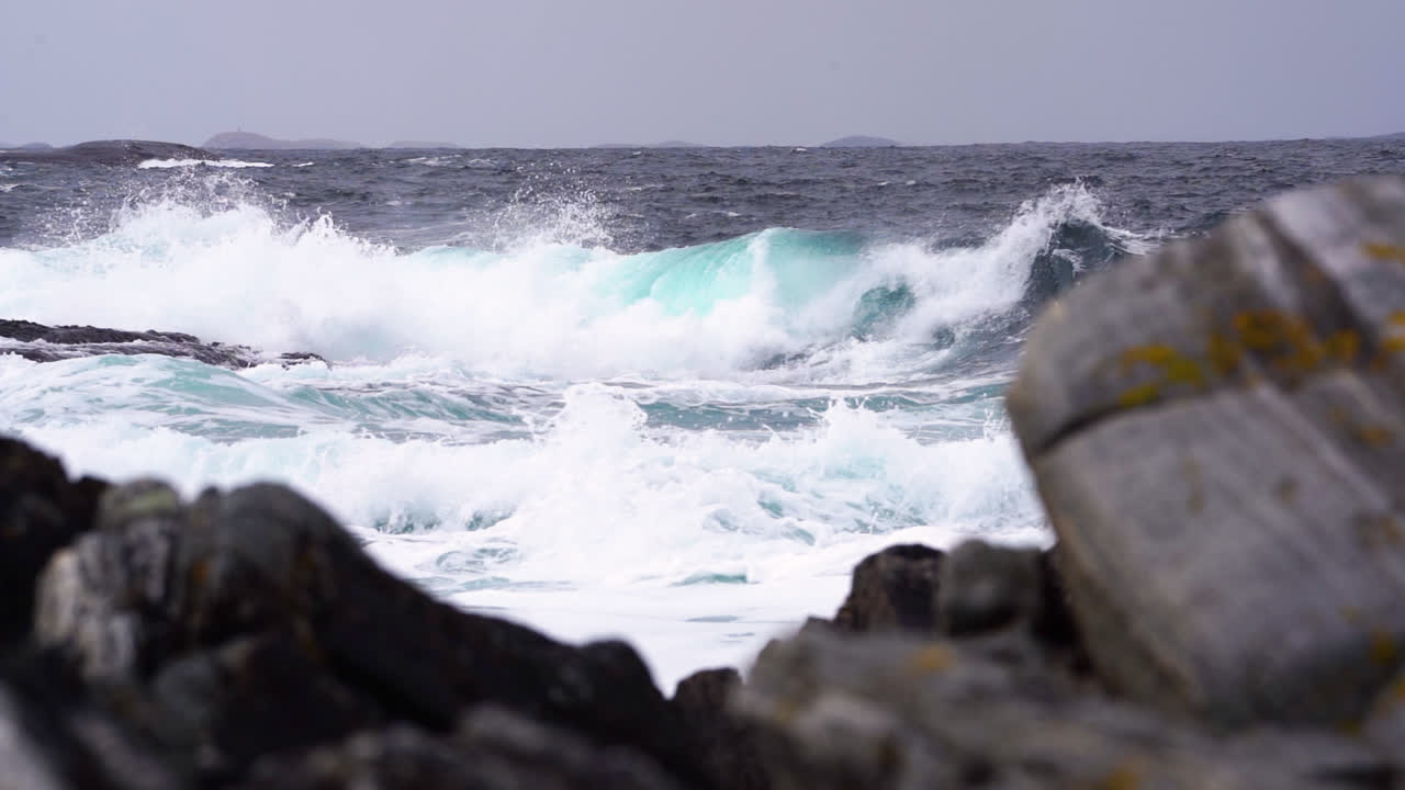 A breaking wave. Rough coastal scenery. Slow motion.