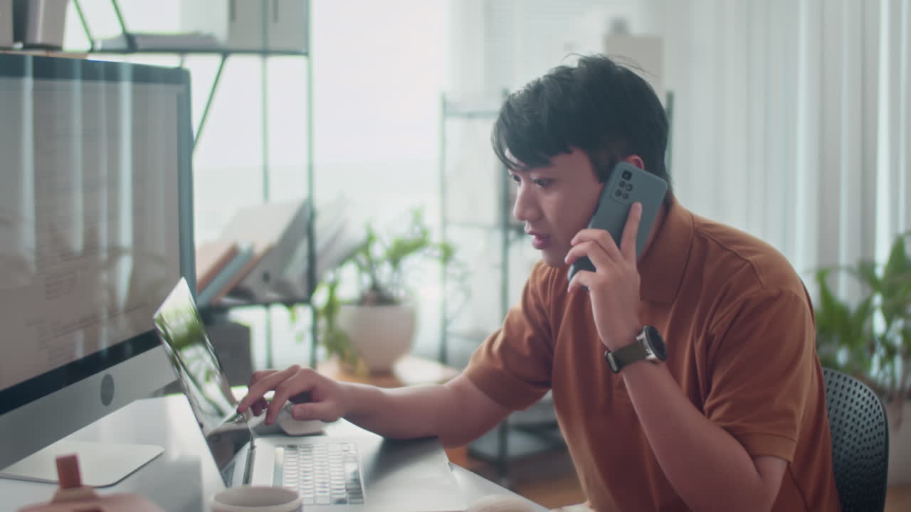 Developer Calling on Phone and Testing Code on Computer