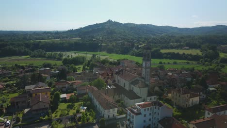 establisher aerial view of pagnano townscape with church tower, circle pan