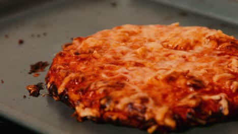 pizza de margarita cocida descansando en la bandeja de horneado