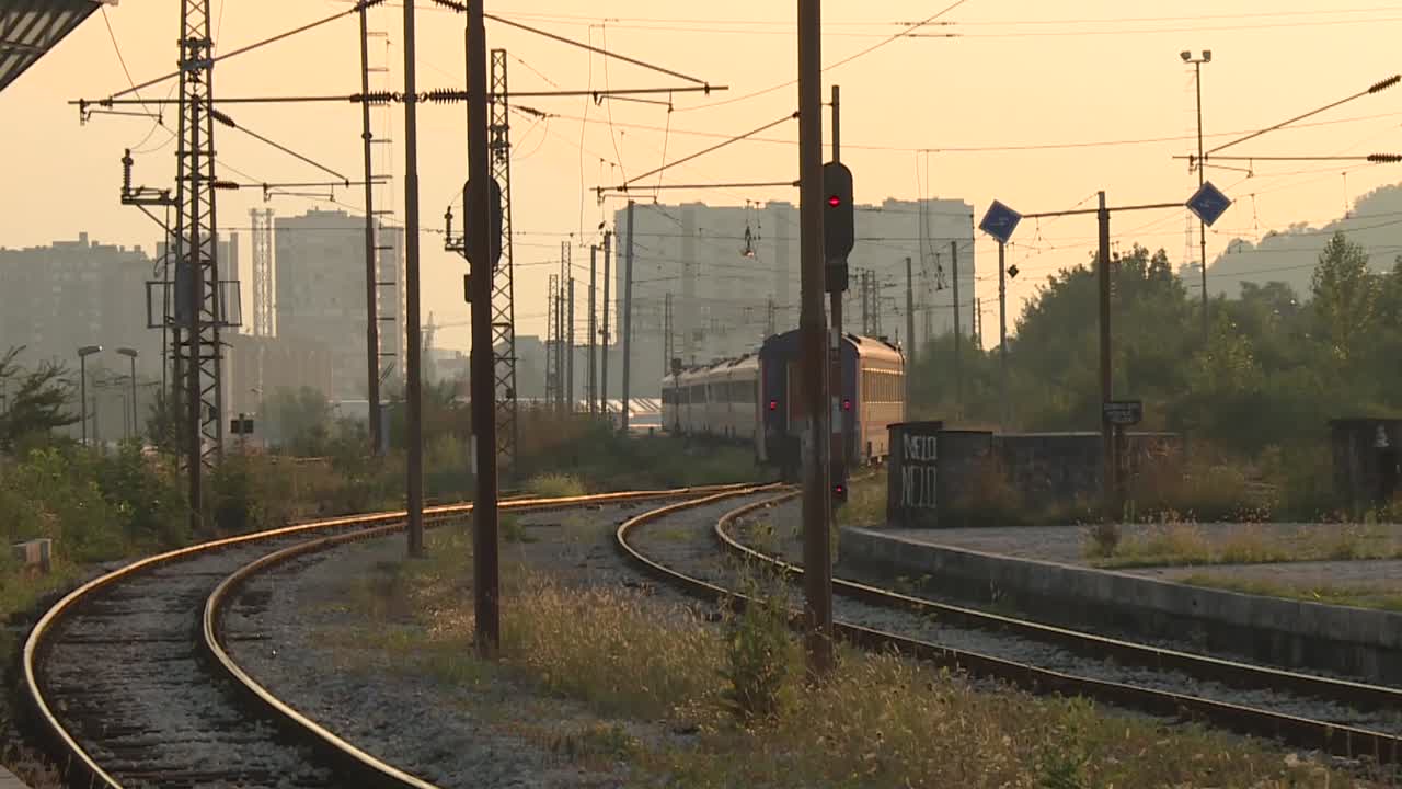 Train Approaching Railway Station at Sunset